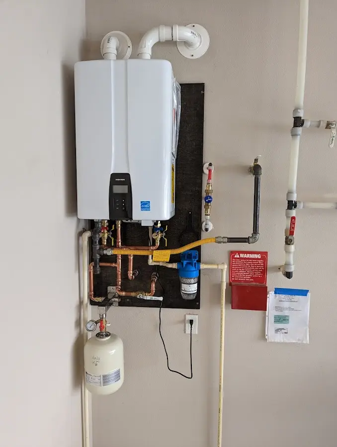 Professional plumber installing copper piping in a Batavia home